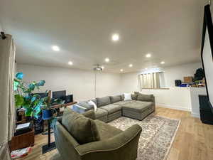 Living room with recessed lighting and light wood-style floors
