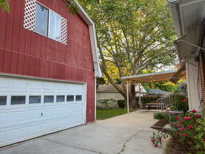 Garage featuring concrete driveway