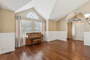 Sitting room with lofted ceiling and wood finished floors