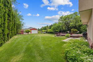 View of grassy yard with a garage
