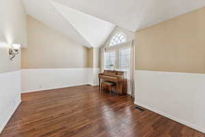 Bonus room with wood finished floors and lofted ceiling
