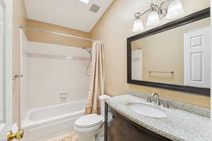 Full bathroom with shower / bath combo with shower curtain and vanity