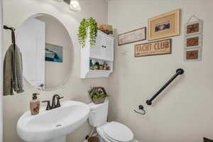 Half bath featuring a sink and toilet