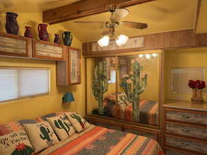Bedroom featuring multiple windows and a ceiling fan