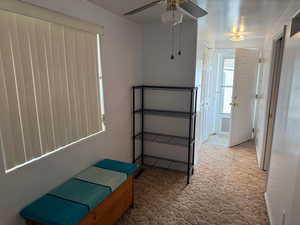 Unfurnished bedroom featuring carpet floors and a ceiling fan