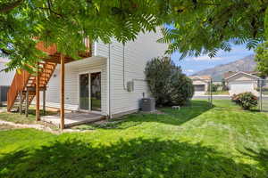 View of home's exterior featuring a mountain view, stairway, and a gate