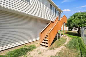 View of side of property featuring stairs