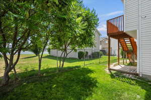 Fenced backyard featuring stairway and a wooden deck