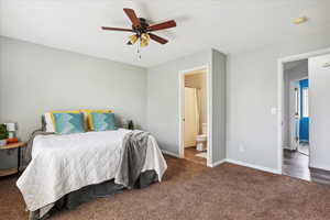 Bedroom featuring carpet floors, ensuite bath, and ceiling fan