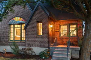 View of front of property featuring brick siding and a shingled roof