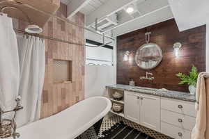 Bathroom with vanity and wooden walls