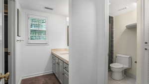 Full bath featuring vanity and toilet