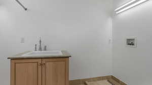 Laundry area featuring washer hookup and tile patterned floors