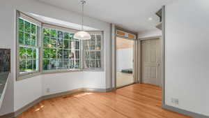 Unfurnished dining area featuring healthy amount of natural light, light wood-style floors, and recessed lighting