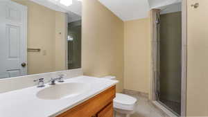 Bathroom featuring vanity, tile patterned flooring, and a stall shower
