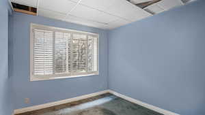 Carpeted spare room with baseboards