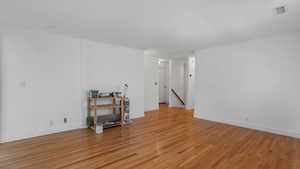 Spare room featuring light wood-type flooring and a smoke detector