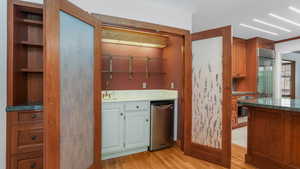 Kitchen featuring light wood-style flooring, appliances with stainless steel finishes, and open shelves