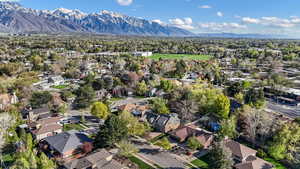 Aerial view of property and surrounding area with nearby suburban area