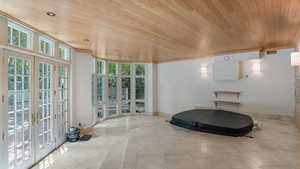 Workout area with wood ceiling, french doors, tile patterned flooring, recessed lighting, and ornamental molding