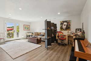 Living area featuring wood finished floors, recessed lighting, and a textured ceiling