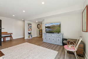 Living area featuring light wood-style floors and recessed lighting