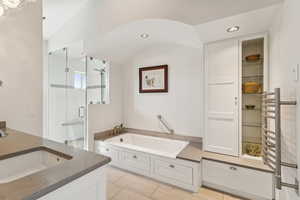 Bathroom featuring a garden tub, a stall shower, vanity, and recessed lighting