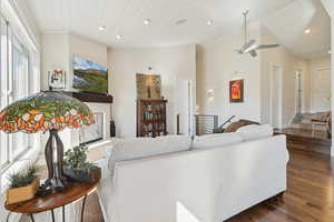 Living area featuring dark wood-style flooring, a ceiling fan, recessed lighting, vaulted ceiling, and wooden ceiling