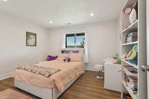 Bedroom featuring wood finished floors and recessed lighting