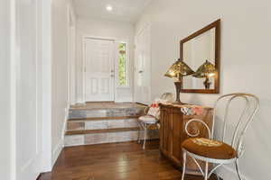 Foyer entrance with hardwood / wood-style flooring, recessed lighting, and ornamental molding