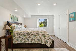 Bedroom with wood finished floors and recessed lighting