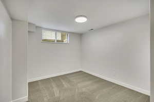 Basement with baseboards and carpet floors