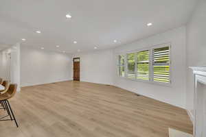 Unfurnished living room featuring recessed lighting and light wood-style flooring