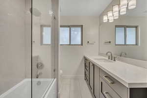 Full bathroom with vanity, tile patterned floors, and tub / shower combination