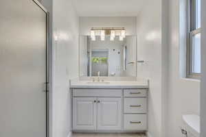 Bathroom featuring vanity and an enclosed shower