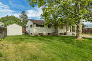 Rear view of house with a storage unit