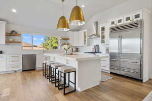 The open-plan kitchen features quartz counters and stunning accent lighting.