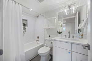 Full bathroom with shower / tub combo and vanity