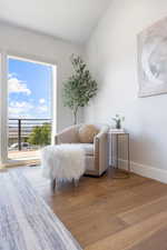 Living area featuring wood finished floors and vaulted ceiling