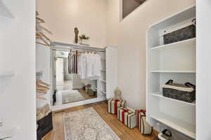 Walk in closet featuring wood finished floors