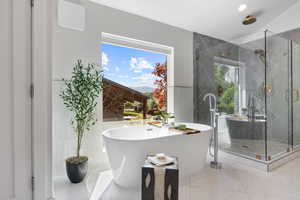 Bathroom with a stall shower, a freestanding bath, marble finish flooring, and recessed lighting