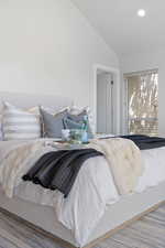 Bedroom featuring lofted ceiling and recessed lighting