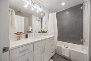 Full bath with vanity, shower / tub combo, tile patterned floors, and recessed lighting