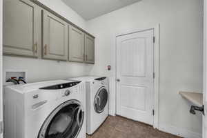 Laundry area with cabinet space and washer and dryer