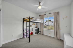 Unfurnished bedroom with light carpet and ceiling fan