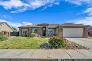 Prairie-style home featuring stucco siding, driveway, a garage, and a tiled roof