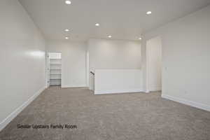 Carpeted spare room featuring recessed lighting