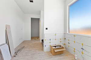 Hallway featuring light wood-style flooring