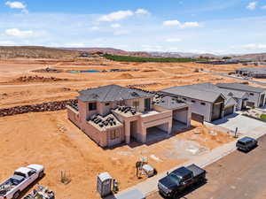 Aerial view of property and surrounding area featuring a desert landscape and mountains
