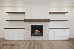 Unfurnished living room with light wood-style floors, a fireplace, and recessed lighting